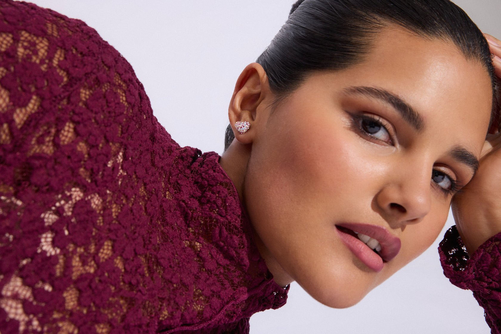 Venetian Blush Sparkle Heart stud earrings worn with a burgundy lace top